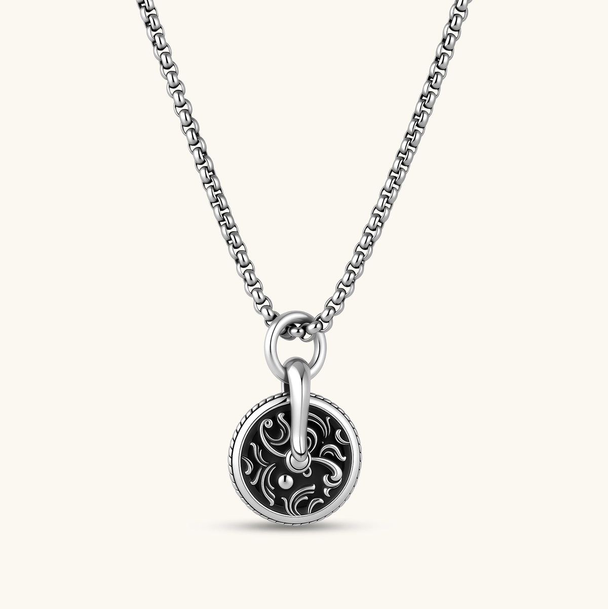 Round 925 sterling silver medallion charm with black enamel fill, scrollwork engraving, rope border, and bold bail ring.