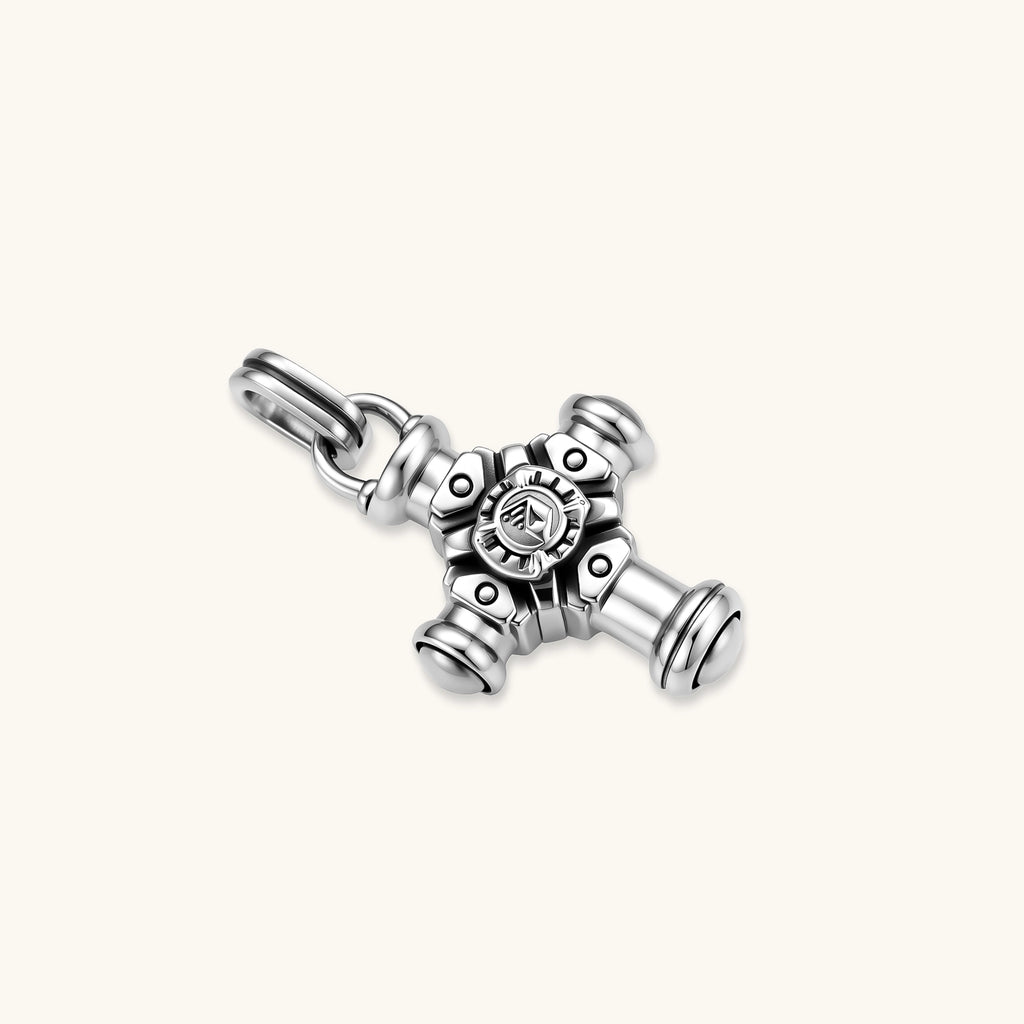 Sterling silver cross pendant with cylindrical arms, floral center medallion, and engraved emblem, shown solo and on a box chain.