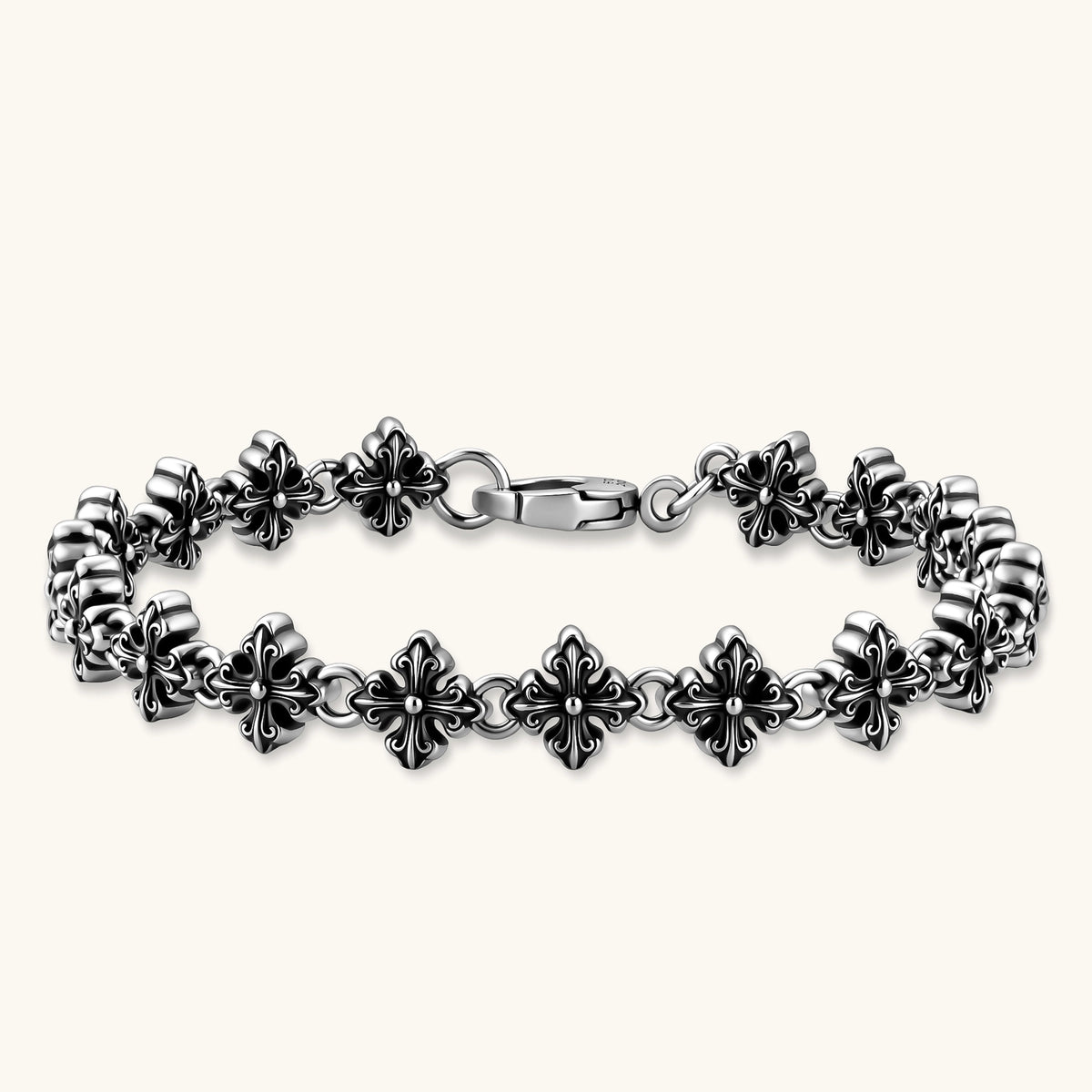 Oxidized 925 sterling silver bracelet with fleur-de-lis cross links and lobster clasp, 8.2mm wide on white background.