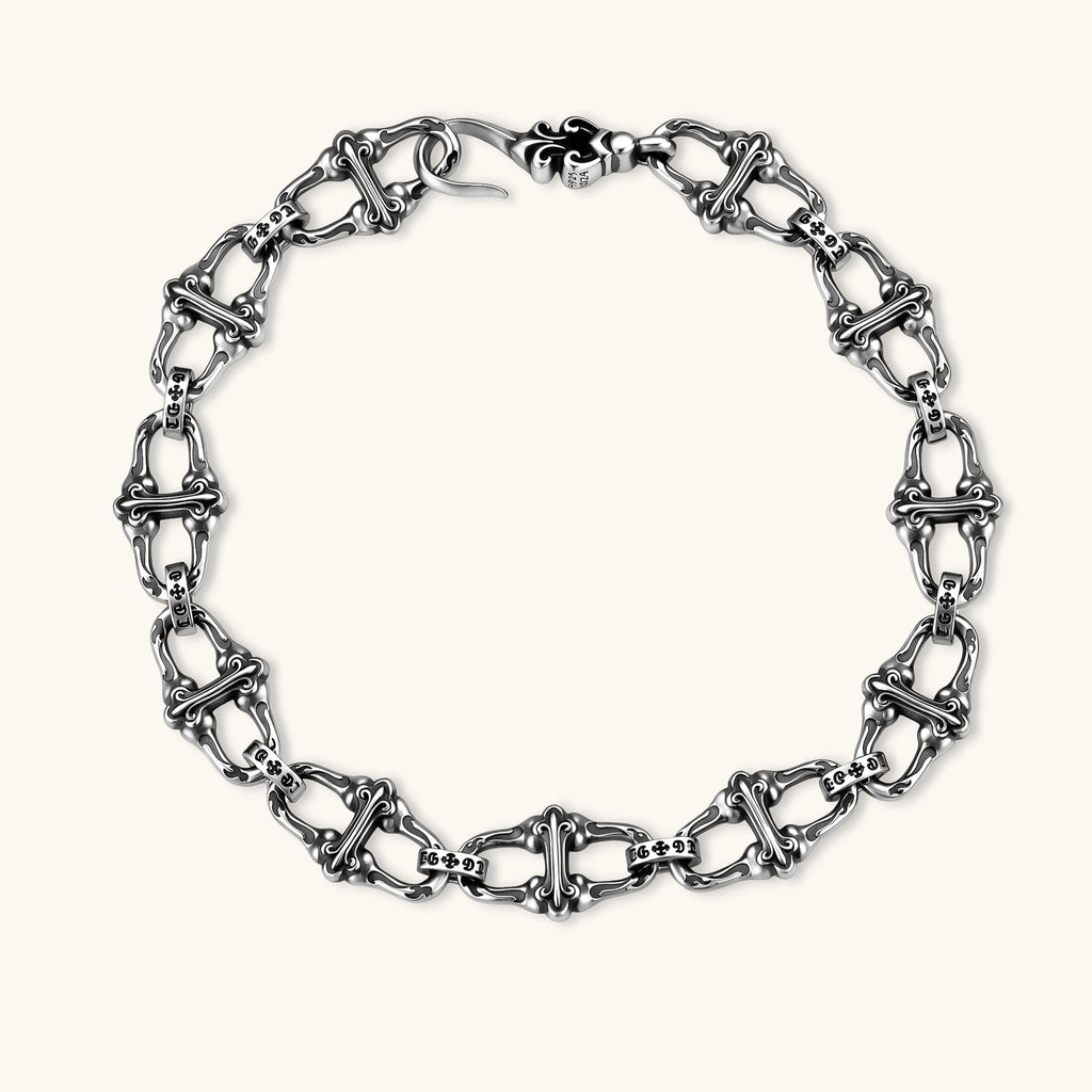 Sterling silver link bracelet with fleur-de-lis cross motifs, oxidized detailing, and hook clasp, 200mm length.