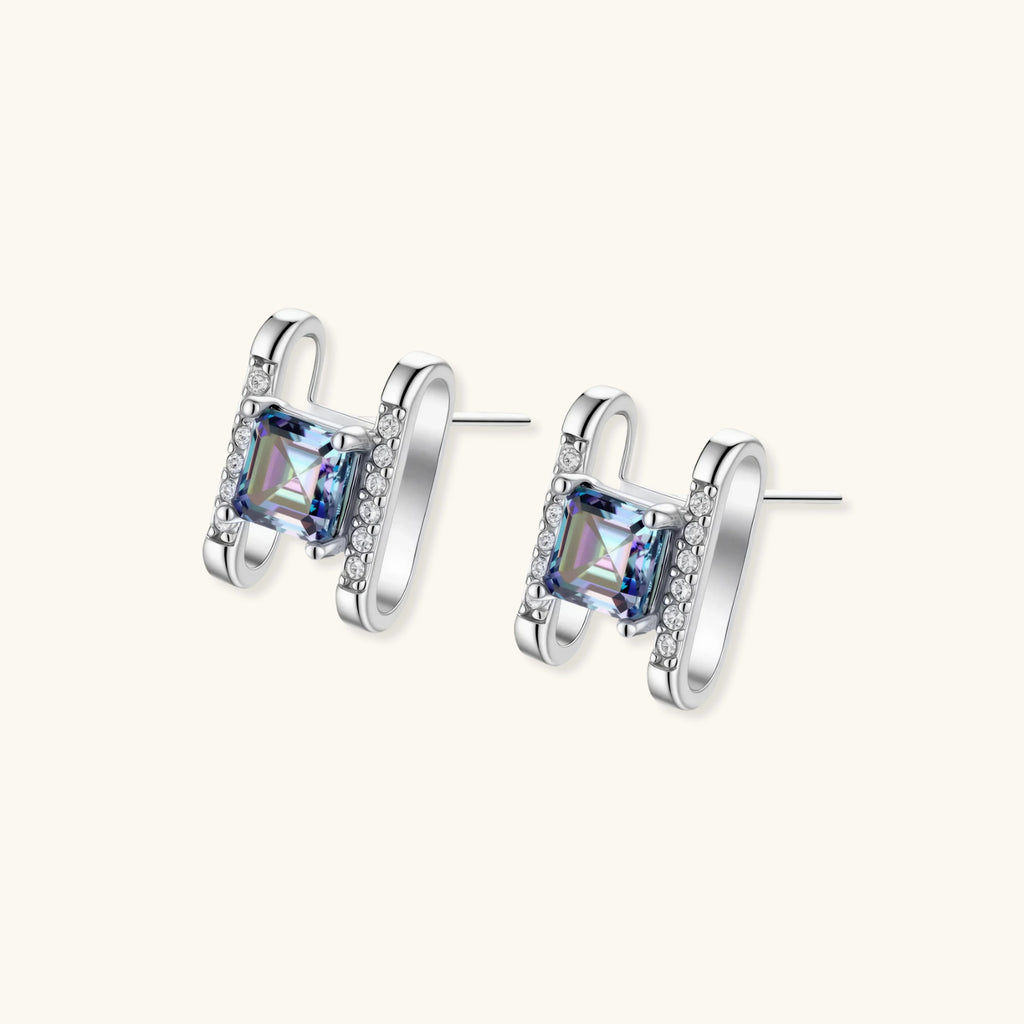 Square moissanite studs in sterling silver geometric setting showing rainbow prismatic fire on white background.