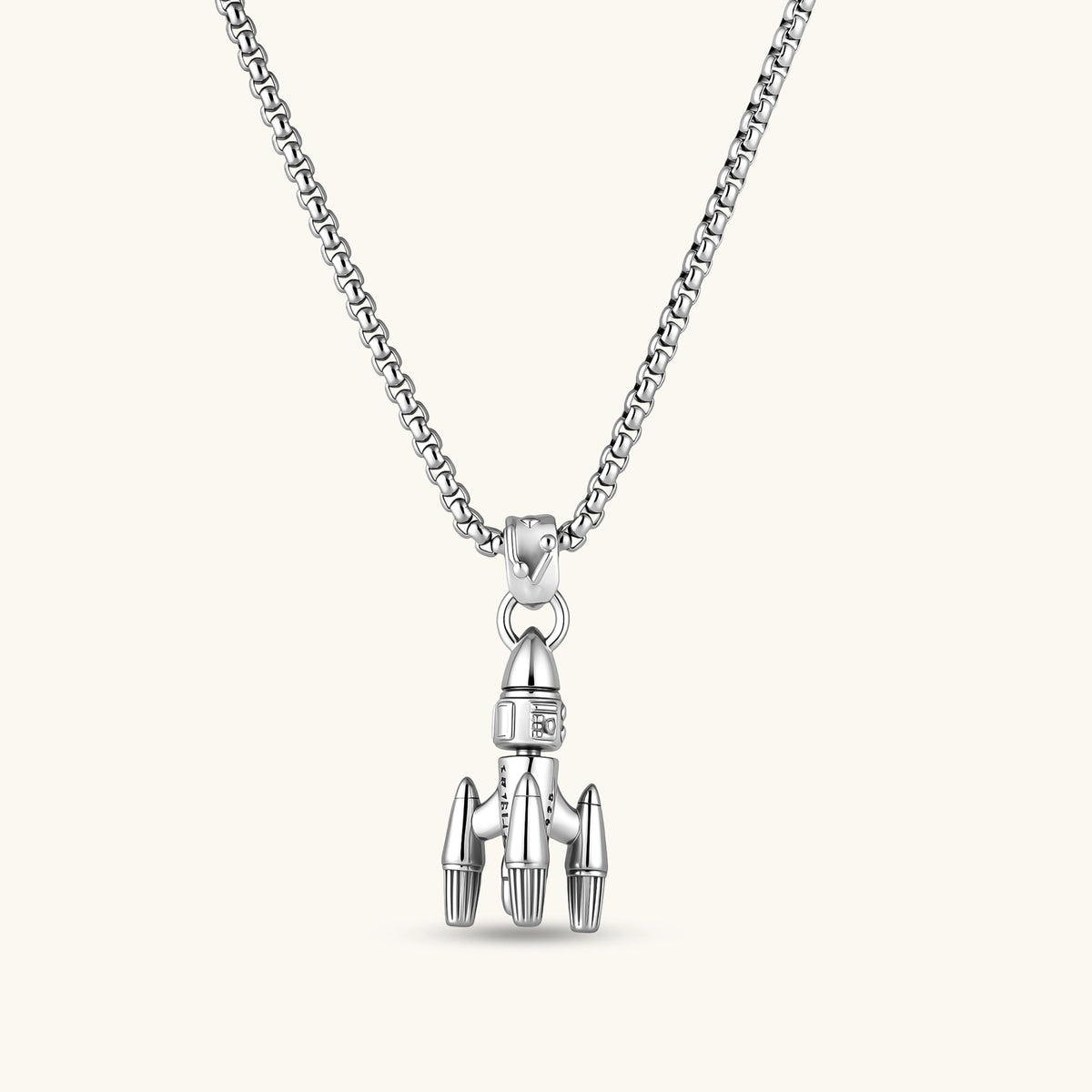 925 sterling silver rocket pendant with bullet-tip nose cone, ribbed boosters, and three fins on a box chain.