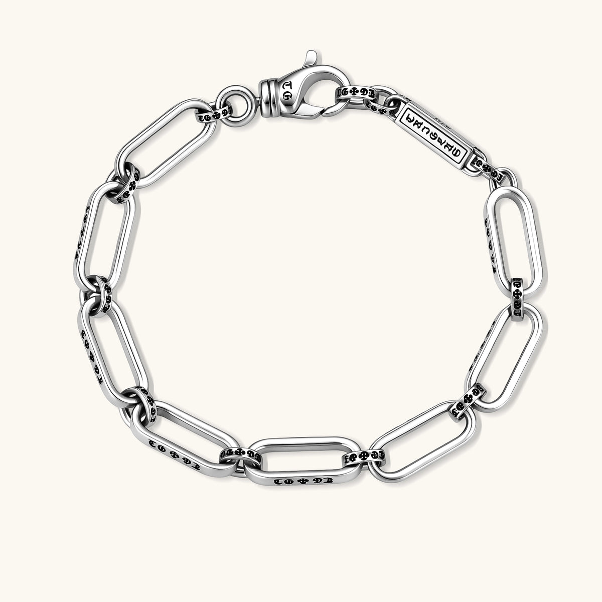 Sterling silver bar-link chain bracelet with oxidized Gothic text engravings and toggle clasp, 7.3mm wide, on white background.