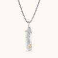 Sterling silver feather pendant with engraved quill texture, gold-tone rivet detail, talon wrap accent, on a box chain.