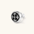 Round sterling silver stud earring with black enamel background and fleur-de-lis cross motif, butterfly push-back closure.