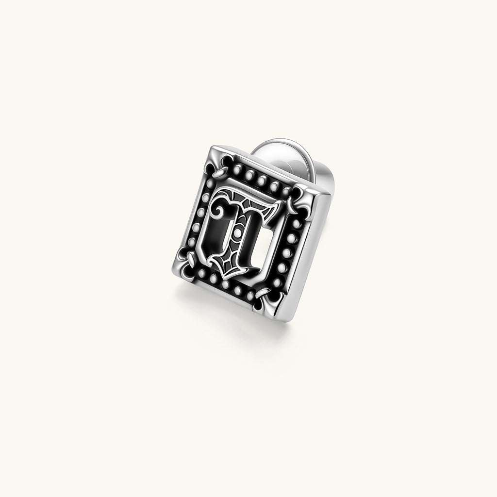 Square 925 sterling silver stud earring with oxidized Gothic letter, ornate dot border, fleur-de-lis corners, butterfly back.