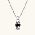 Sterling silver baroque floral cross pendant on a box chain, with oxidized black scrollwork detailing, 45mm length.