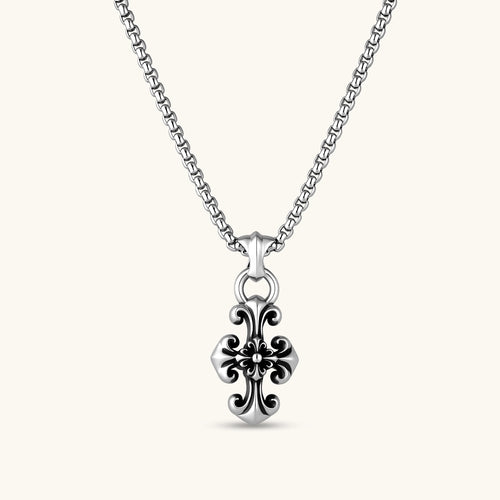Sterling silver baroque floral cross pendant on a box chain, with oxidized black scrollwork detailing, 45mm length.