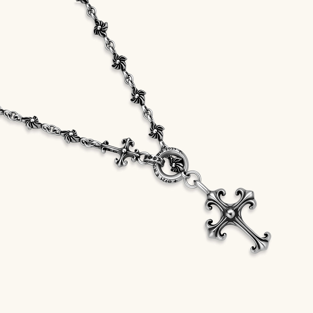 Sterling silver necklace with ornate floral-link chain, ring clasp, cross toggle bar, and Gothic fleur cross pendant.