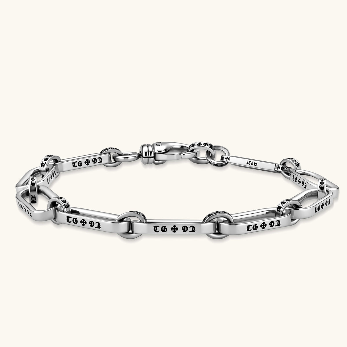 Sterling silver bar-link chain bracelet with oxidized Gothic text engravings and toggle clasp, 7.3mm wide, on white background.
