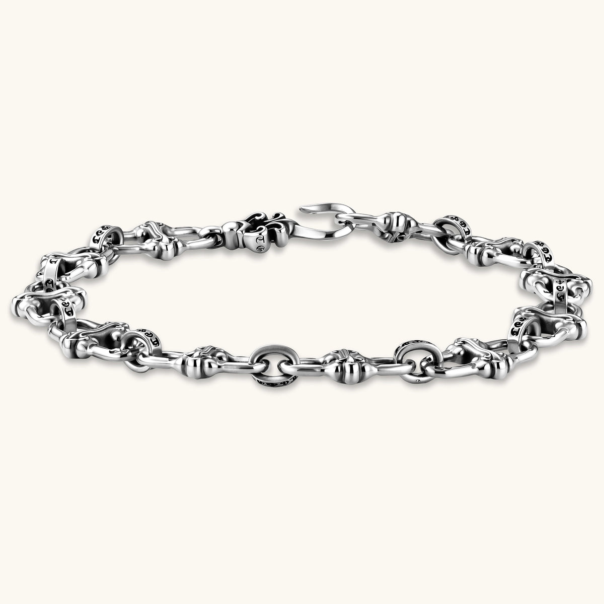Sterling silver link bracelet with fleur-de-lis cross motifs, oxidized detailing, and hook clasp, 200mm length.