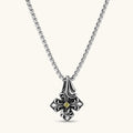 Sterling silver oxidized fleur-de-lis cross pendant with yellow gemstone center on a box chain, 36mm drop.