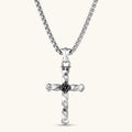925 sterling silver twisted cross pendant with black enamel sun motif center, on a box chain, cream background.