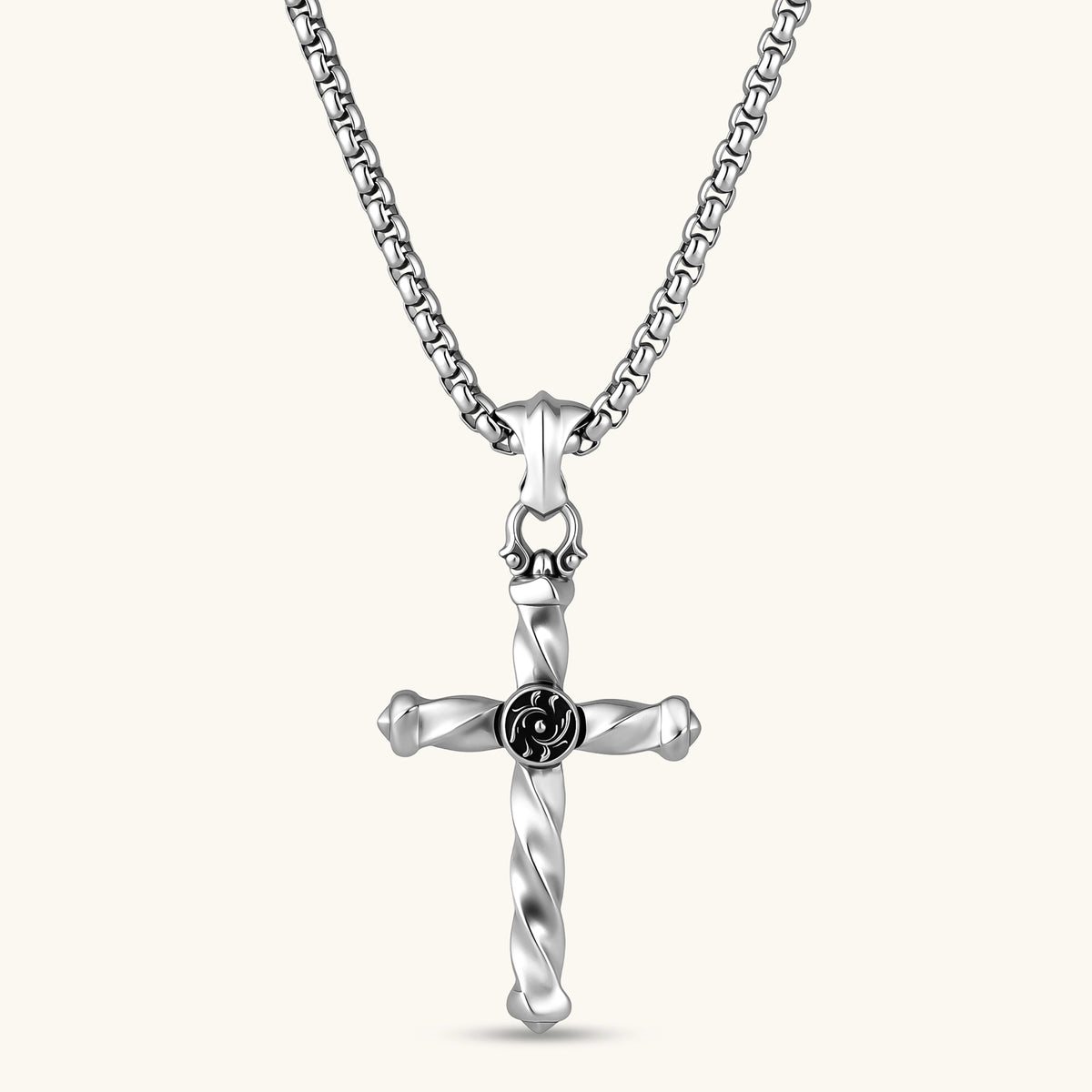 925 sterling silver twisted cross pendant with black enamel sun motif center, on a box chain, cream background.