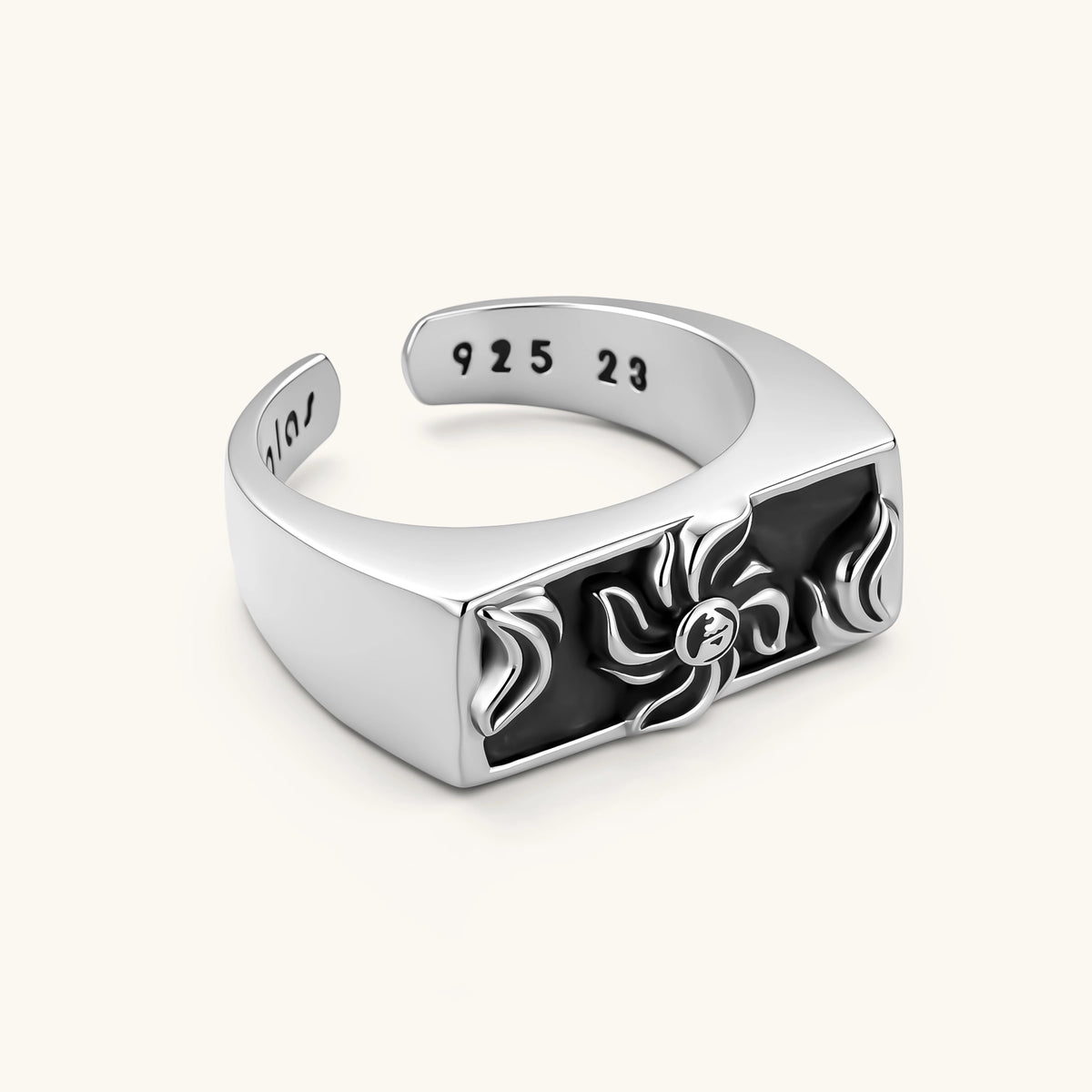 925 sterling silver open signet ring with rectangular black enamel face and raised silver sun-spider motif, adjustable band.