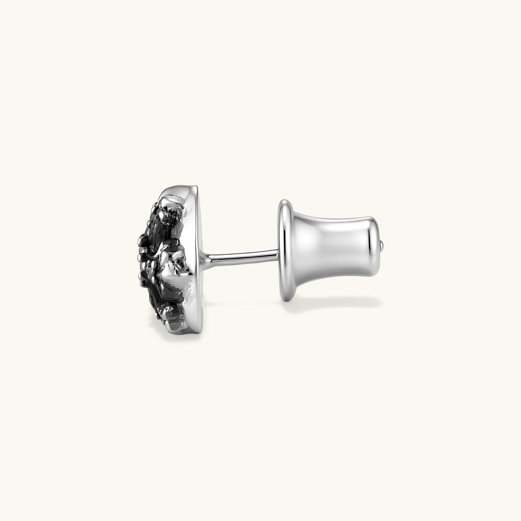 Sterling silver dome stud earring with oxidized black petals, ornate scrollwork, and clear cubic zirconia stones, butterfly back.