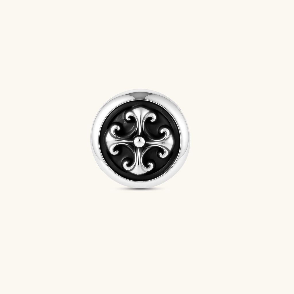 Round sterling silver stud earring with black enamel background and fleur-de-lis cross motif, butterfly push-back closure.