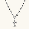 Sterling silver necklace with ornate floral-link chain, ring clasp, cross toggle bar, and Gothic fleur cross pendant.