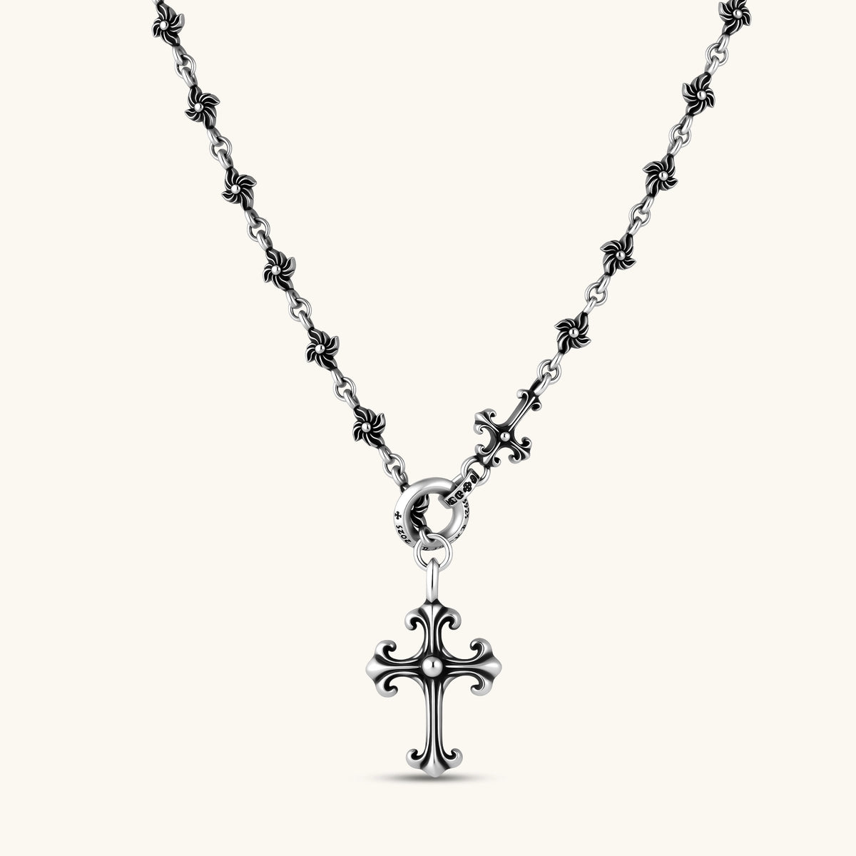 Sterling silver necklace with ornate floral-link chain, ring clasp, cross toggle bar, and Gothic fleur cross pendant.