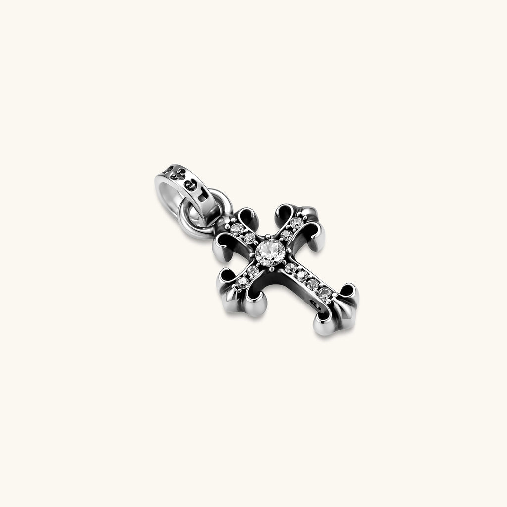 Sterling silver gothic cross pendant with ornate fleur-de-lis tips, pavé crystals, and center stone on a box chain.