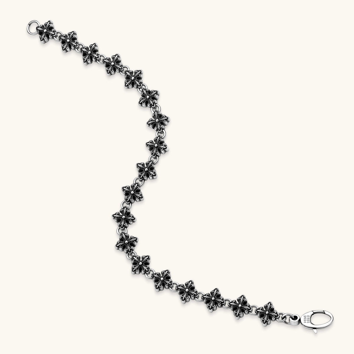 Oxidized 925 sterling silver bracelet with fleur-de-lis cross links and lobster clasp, 8.2mm wide on white background.