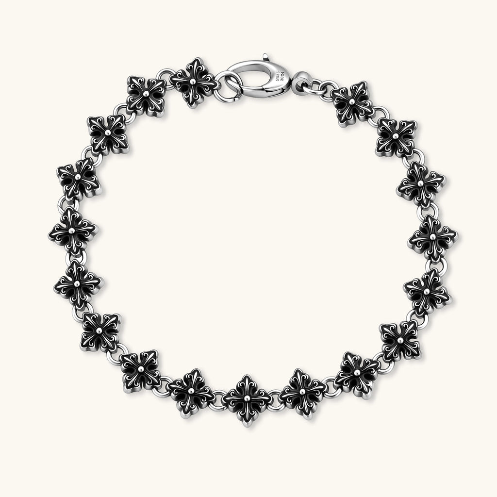 Oxidized 925 sterling silver bracelet with fleur-de-lis cross links and lobster clasp, 8.2mm wide on white background.