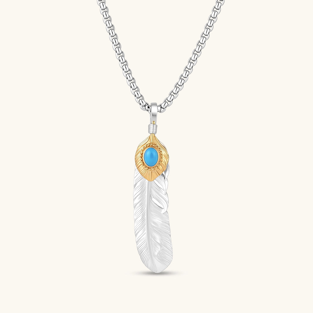 Sterling silver feather pendant with gold-tone base and oval turquoise cabochon, detailed quill engraving, 67mm length.