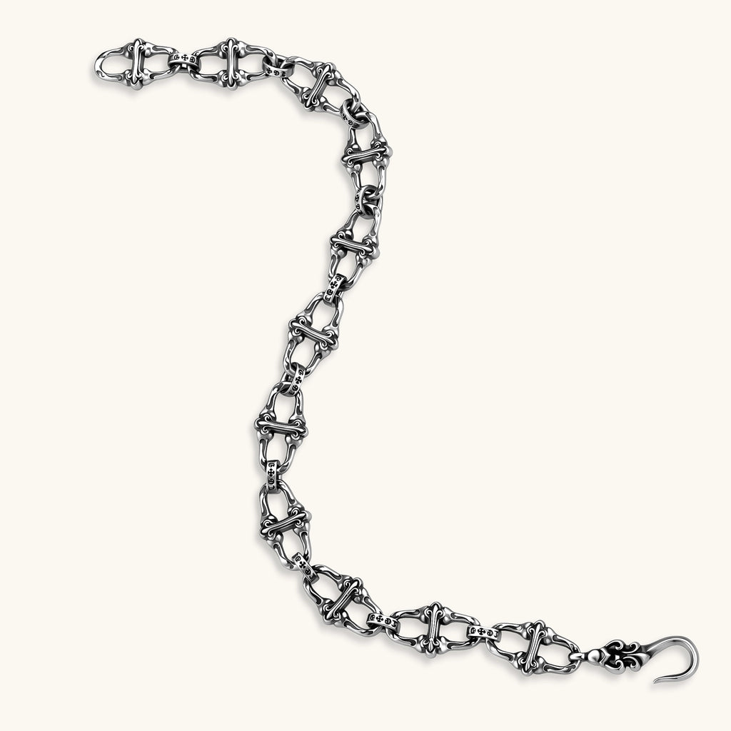 Sterling silver link bracelet with fleur-de-lis cross motifs, oxidized detailing, and hook clasp, 200mm length.
