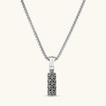 Sterling silver cylindrical pendant with black oxidized anchor lattice pattern on a box chain, 40mm length.