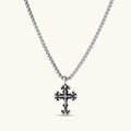 Ornate oxidized sterling silver gothic cross pendant with fleur-de-lis tips and pavé crystal accents on a box chain.