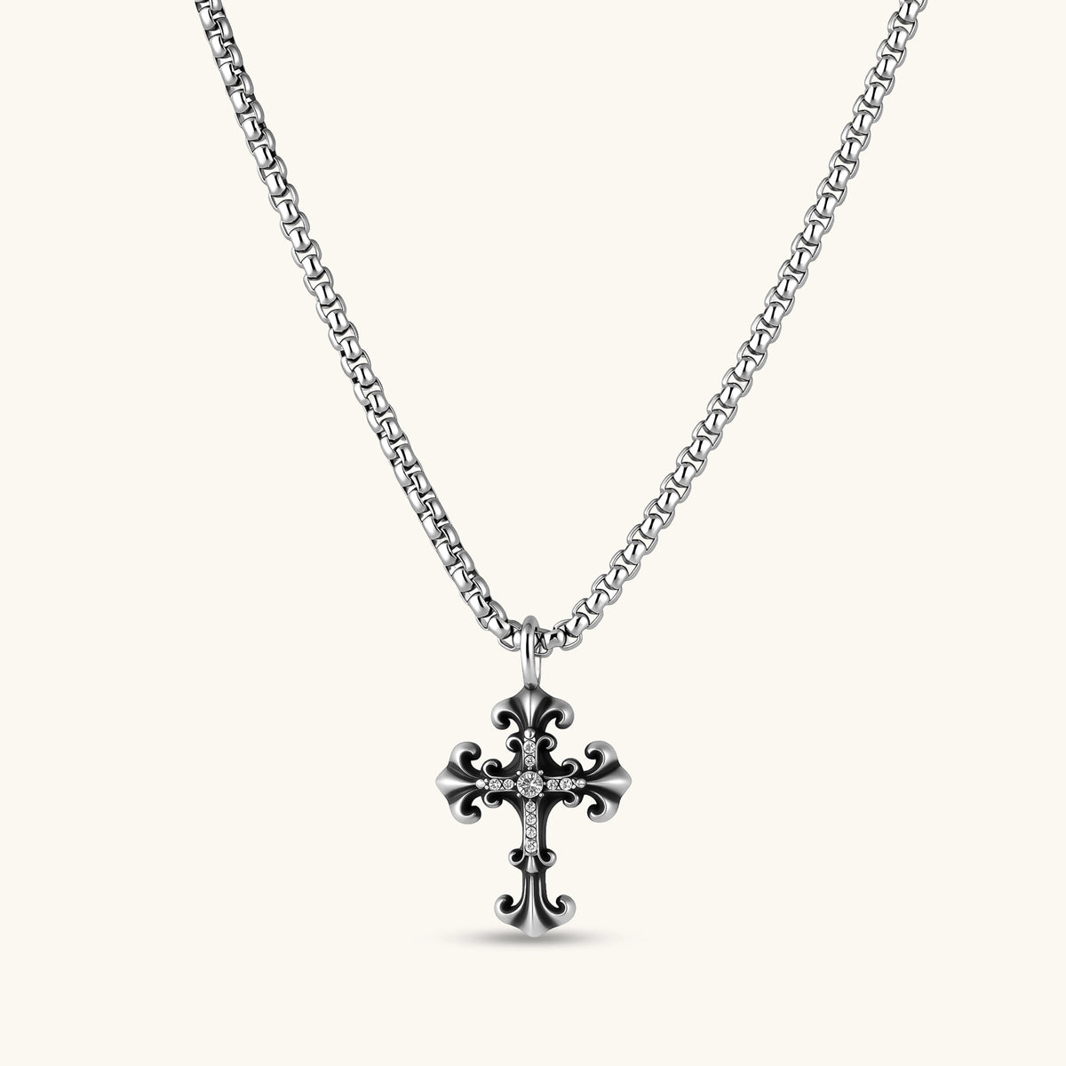 Ornate oxidized sterling silver gothic cross pendant with fleur-de-lis tips and pavé crystal accents on a box chain.